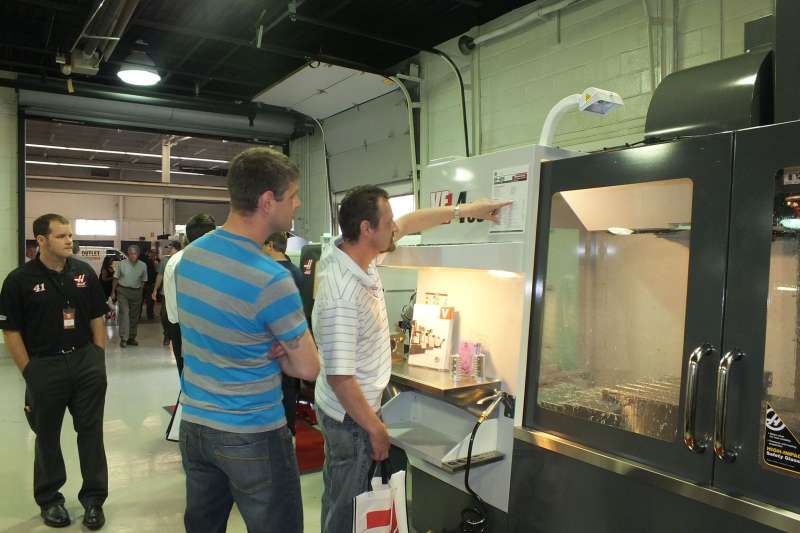 Jimmie Thiessen, left, with brother John, examine the VF4 vertical machining centre.