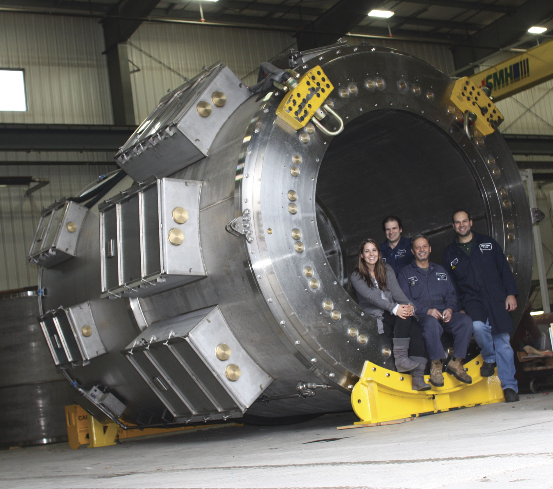 This 31,751 kg (70,000 lb) high voltage slip ring for a floating production, storage and offloading vessel was shipped to Brazil. The part is made mostly of stainless steel, copper and composite materials. Inside the part from left: Monica Boaretto, treasurer; Dan Boaretto, president; Ali Solhdoust, plant manager; and Peter Boaretto, vice president.