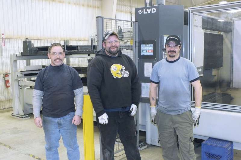 Matt Murphy, far left, and Chris Haalstra, middle, who were part of the metal fabricating team that made the decision to purchase a laser cutting system. Mike Catherwood, far right, also works in the fabrication shop.