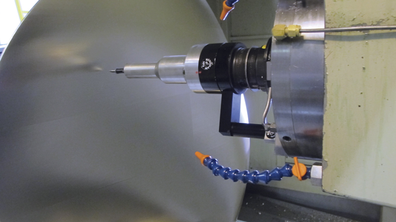 A probe measures the tolerances of a finished part. 