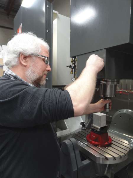 Keith Clausen, seen here, and his partner Marcus Carius, are impressed with the performance of their five axis Haas machine.