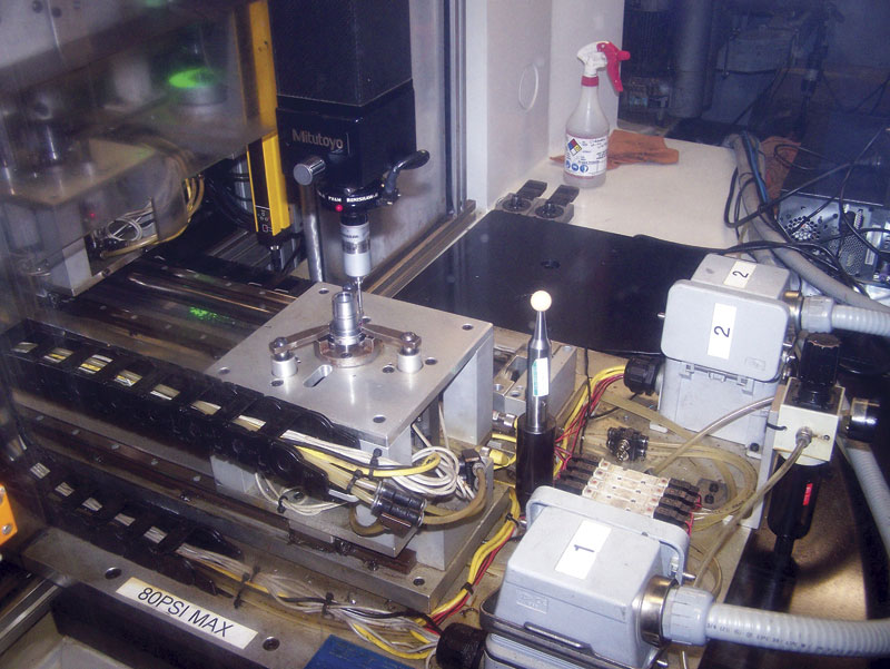 A close up view of the Mitutoyo CMM measuring a part at Glueckler Metal Inc. (GMI)