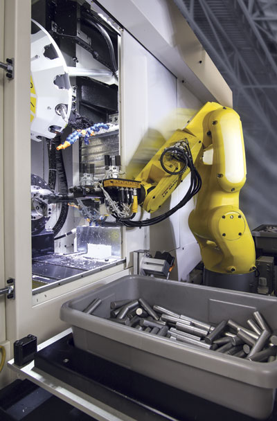Vision-equipped robots are clever enough to pick raw material blanks out of a box, orient them properly, and keep the machine running, just like a human would.  Image: FANUC