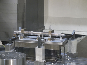 A shaft set to be milled in a milling machine. Once the shafts are machined on the Studer grinder, they undergo a milling process.