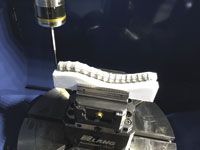 Probing the spine replica on a Doosan five axis machining centre. As you can see, a special set of jaws was needed to grip the oddly-shaped workpiece.  Image: Renishaw Ltd. 