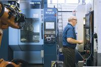 Bill Goodwin, technical team leader at Avior, checks a part in the Mazak machine. Avior joined the new Matsuura machine, seen in this image, with this Mazak VMC to create a palletized, lights out machining cell.
