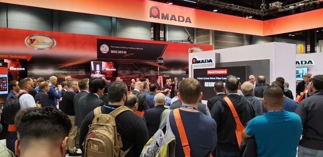 Attendees at Amada's booth to hear about debut fiber laser cutting and bending.