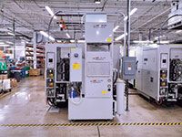 This Chipblaster system sits directly behind the machine tool and contains a high pressure pump, chiller unit and mist control unit (at top).LNS North America